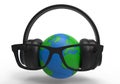 Headphones on earth globe Royalty Free Stock Photo