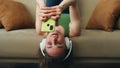 Headphones girl laying sofa listening music closeup. Happy woman texting phone Royalty Free Stock Photo