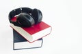 Headphones and group of books with isolated background. Royalty Free Stock Photo