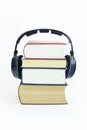 Headphones and group of books with isolated background. Royalty Free Stock Photo