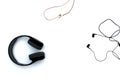 Large and small headphones lie on a white isolated background. Royalty Free Stock Photo