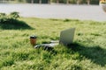 Headphones, laptop, mobile phone on the grass, Listen to music and working concept. Royalty Free Stock Photo