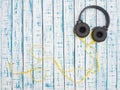 Headphones of a large size with a yellow wire on a wooden table