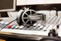 Headphones lying on the mixing console Royalty Free Stock Photo