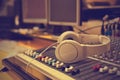 Headphones lying on the mixing console Royalty Free Stock Photo