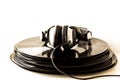 Headphones lying on the stack of vinyl records. Royalty Free Stock Photo