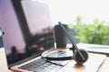 Headphones with microphone lying on laptop keyboard on desktop closeup Royalty Free Stock Photo