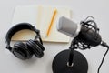 Headphones, microphone and notebook with pencil Royalty Free Stock Photo