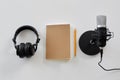 Headphones, microphone and notebook with pencil