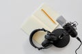 Headphones, microphone and notebook with pencil Royalty Free Stock Photo