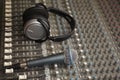 Headphones and microphone on old dirty sound mixer Royalty Free Stock Photo