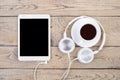 Headphones, mobile phone, idiobook, coffee cup on a wooden table. The concept of leisure and learning, hobby. Listen to music, Royalty Free Stock Photo