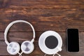 Headphones, mobile phone, idiobook, coffee cup on a wooden table. The concept of leisure and learning, hobby. Listen to music, Royalty Free Stock Photo