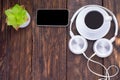 Headphones, mobile phone, idiobook, coffee cup on a wooden table. The concept of leisure and learning, hobby. Listen to music, Royalty Free Stock Photo