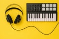 Headphones and music mixer on bright yellow background. The concept of workplace organization. Royalty Free Stock Photo