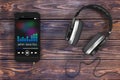 Headphones near Mobile Phone with Music Playlist. 3d Rendering