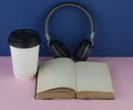 Headphones with open blank book page with copy space. Remote education concept Royalty Free Stock Photo