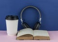 Headphones with open blank book page with copy space. Remote education concept Royalty Free Stock Photo