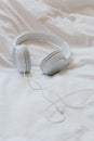 Headphones over a bed. Relaxing moment concept. After-work disconnection. Vertical photo