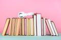 headphones on row of books on table