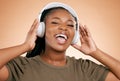 Headphones, singing and portrait of woman isolated on studio background in mental health, energy and radio music. Singer Royalty Free Stock Photo