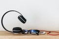 Headphones and smartphone on wood floor with glasses Royalty Free Stock Photo