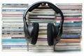 Headphones on a stack of CDs on isolate white background Royalty Free Stock Photo