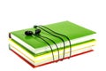 Headphones and stack of multicolored books on a white background Royalty Free Stock Photo