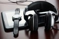 Headphones on a table next to the tablet and a clock Royalty Free Stock Photo