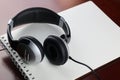 Headphones on a table next to the tablet and a clock Royalty Free Stock Photo