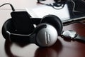 Headphones on a table next to the tablet and a clock Royalty Free Stock Photo