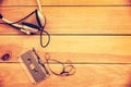 Headphones and translucent audio cassette tape on vintage wood planks  background Royalty Free Stock Photo