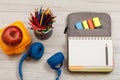 Headphones, yellow sandwich box, apple, metal stand for pencils