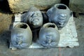 The heads of the clay idols of different shapes are drying in Sun light.