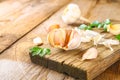 Heads of garlic with parsley on a wooden table. Royalty Free Stock Photo