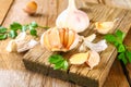 Heads of garlic with parsley on a wooden table. Royalty Free Stock Photo