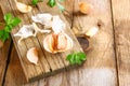 Heads of garlic with parsley on a wooden table. Royalty Free Stock Photo