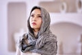Headscarf on head of muslim woman who stands indoors. Royalty Free Stock Photo