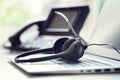 Headset headphones telephone and laptop in call center Royalty Free Stock Photo