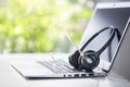 Headset headphones telephone with microphone on laptop and desk in call center Royalty Free Stock Photo