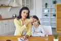 Headshoat portrait of mother and sick daughter speak video chat online using gadget at home.