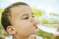 headshot of adorable toddler boy drinking water from plastic bottle Royalty Free Stock Photo