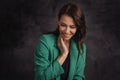 tudio portrait of beautiful brunette haired woman against isolated dark background