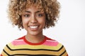 Headshot of attractive tender and friendly-looking outgoing joyful young dark-skinned woman with fair curly haircut in Royalty Free Stock Photo