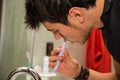 Headshot of attractive young man brushing teeth and tongue Royalty Free Stock Photo