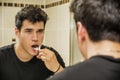 Headshot of attractive young man brushing teeth Royalty Free Stock Photo