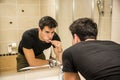 Headshot of attractive young man brushing teeth Royalty Free Stock Photo