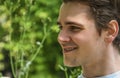 Headshot of attractive young man smiling in nature environment Royalty Free Stock Photo