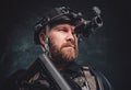 Modern soldier looks in night vision device inbuilt in his helmet Royalty Free Stock Photo