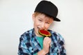 Headshot of beautiful little boy holding and biting lollipop looking at the camera with happy and joyful expression. Handsome boy Royalty Free Stock Photo